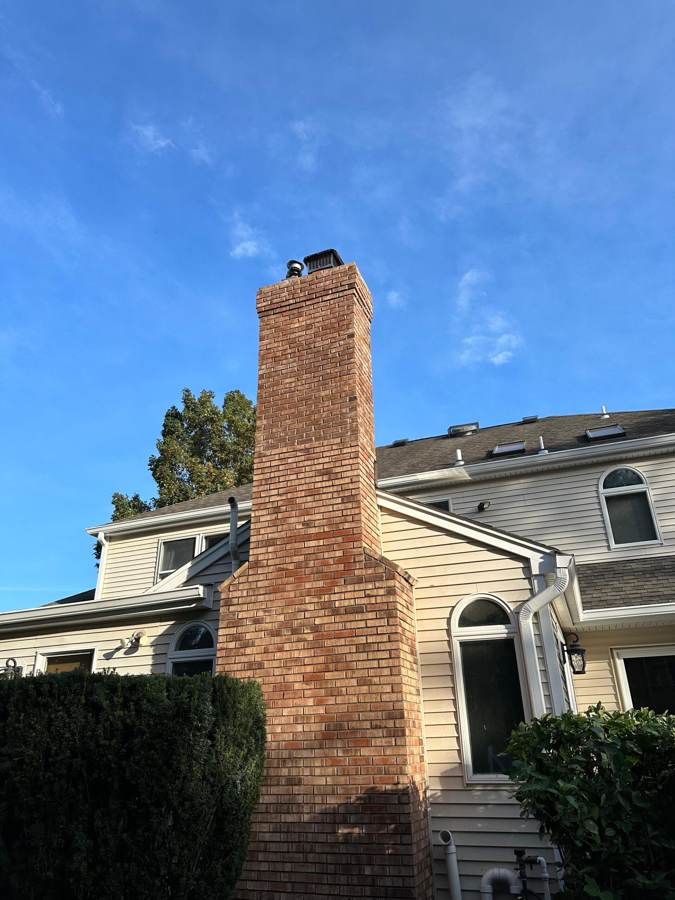 Brick chimney repair on a two-story home