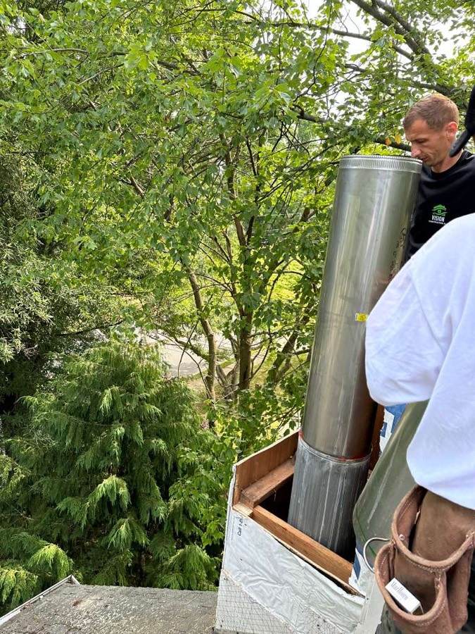 Vision technician installing a stainless steel chimney liner