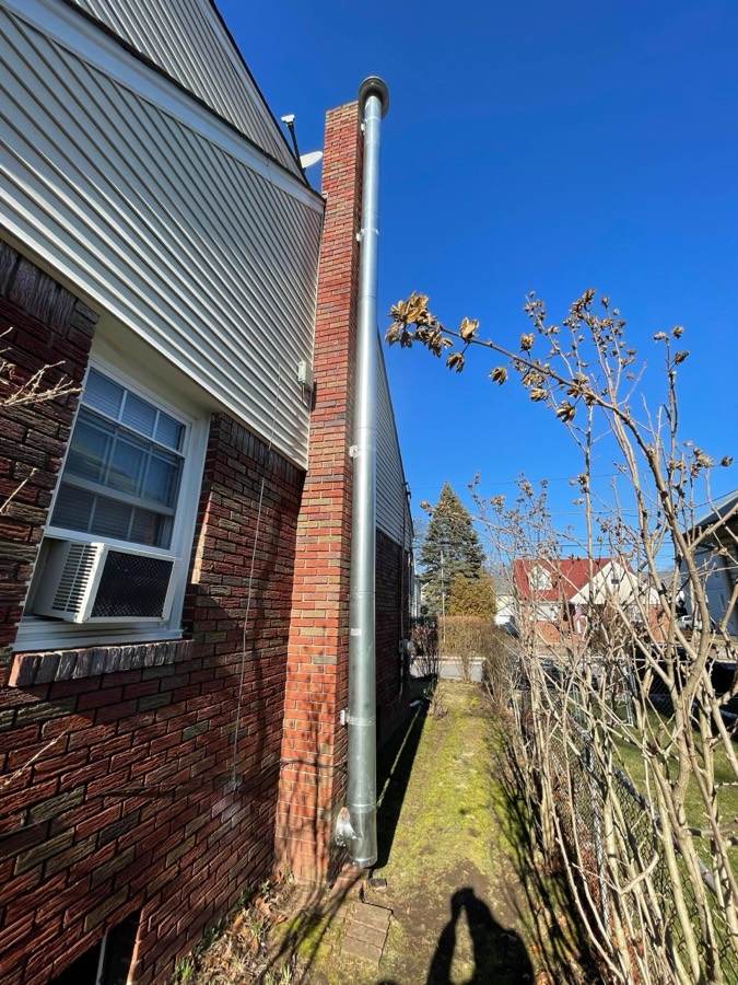Exterior brick chimney on a side wall