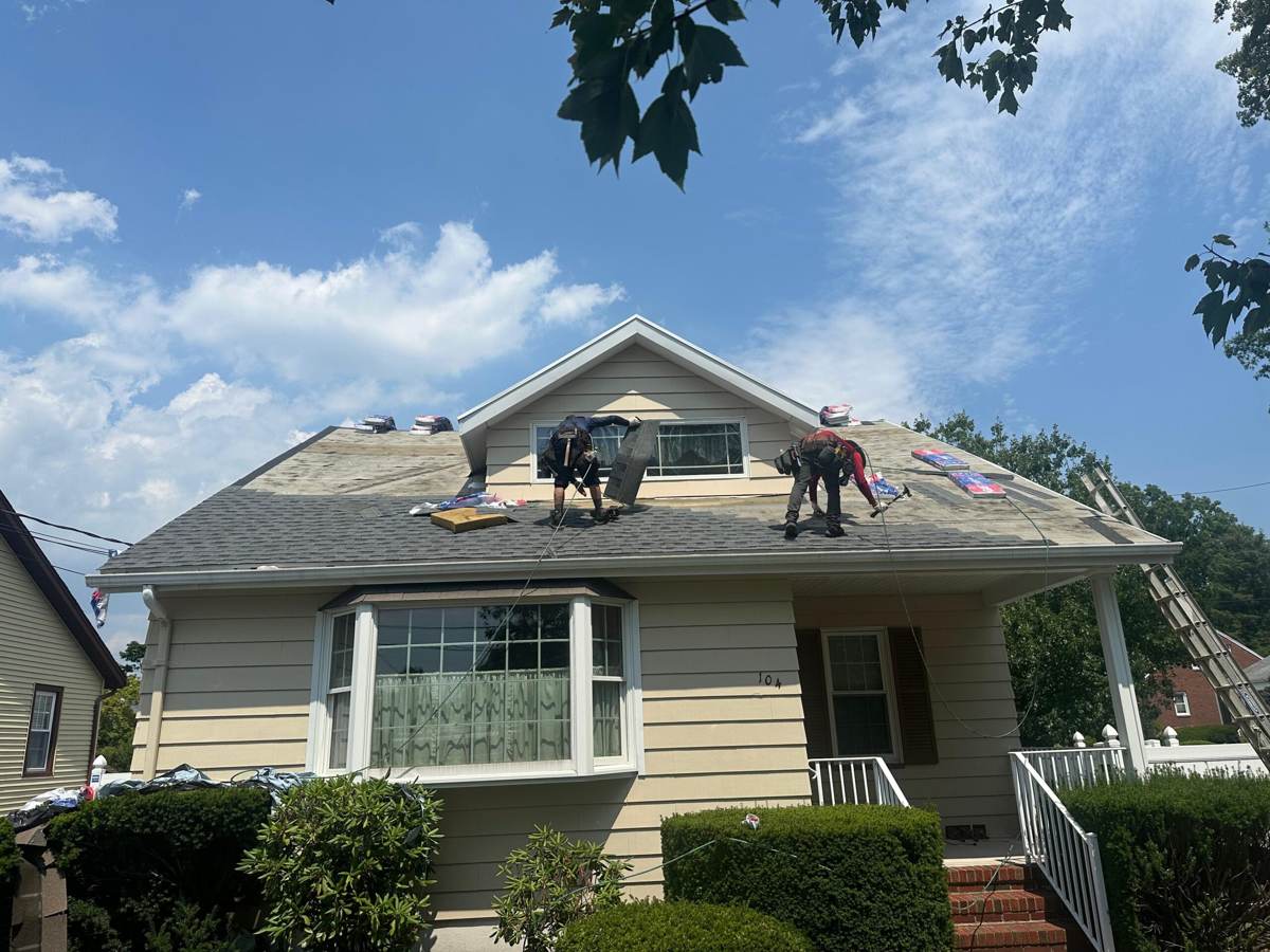 Two Vision technicians working safely on a roof